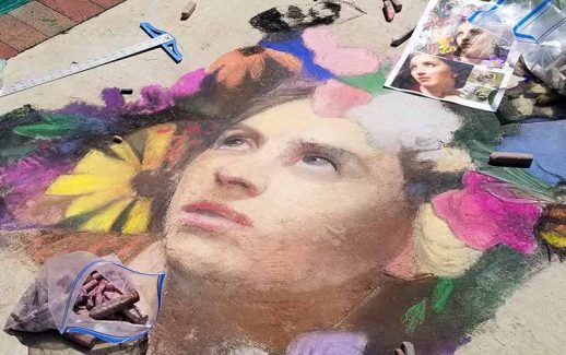 Artists painting vibrant crosswalk murals near the corner of Remington Avenue and Stevens Street, a collaborative public art project aimed at enhancing pedestrian safety and community engagement