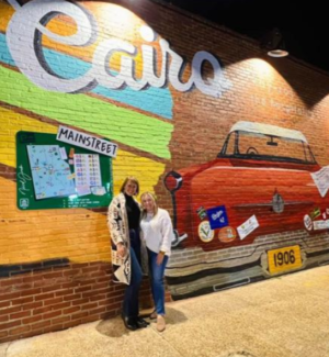 A vibrant mural on the side of Strands Salon in downtown Cairo, designed by artist Nicole Jordan and unveiled through a grant from the Georgia Council for the Arts.