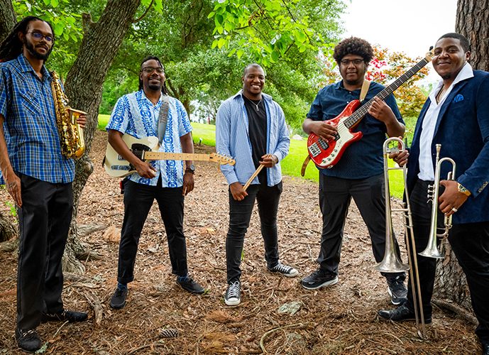 The Pharaohs of Funk band engaging the crowd with their dynamic funk rhythms during their opening set at the festival.
