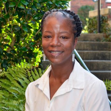 Black and white portrait of artist Laura Patrick, highlighting her background in fine art and design