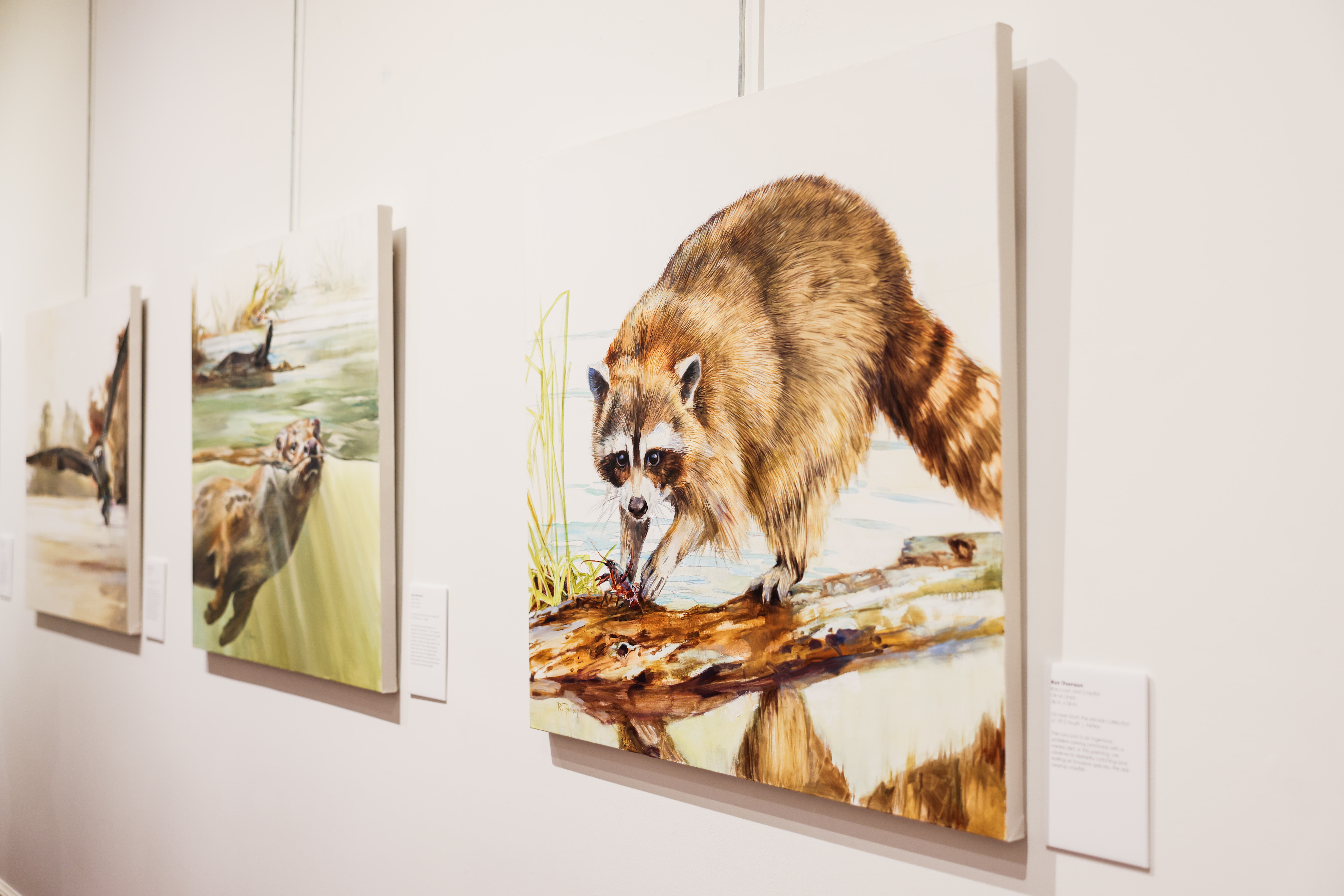 An art gallery within the Center displaying various artworks on the walls.