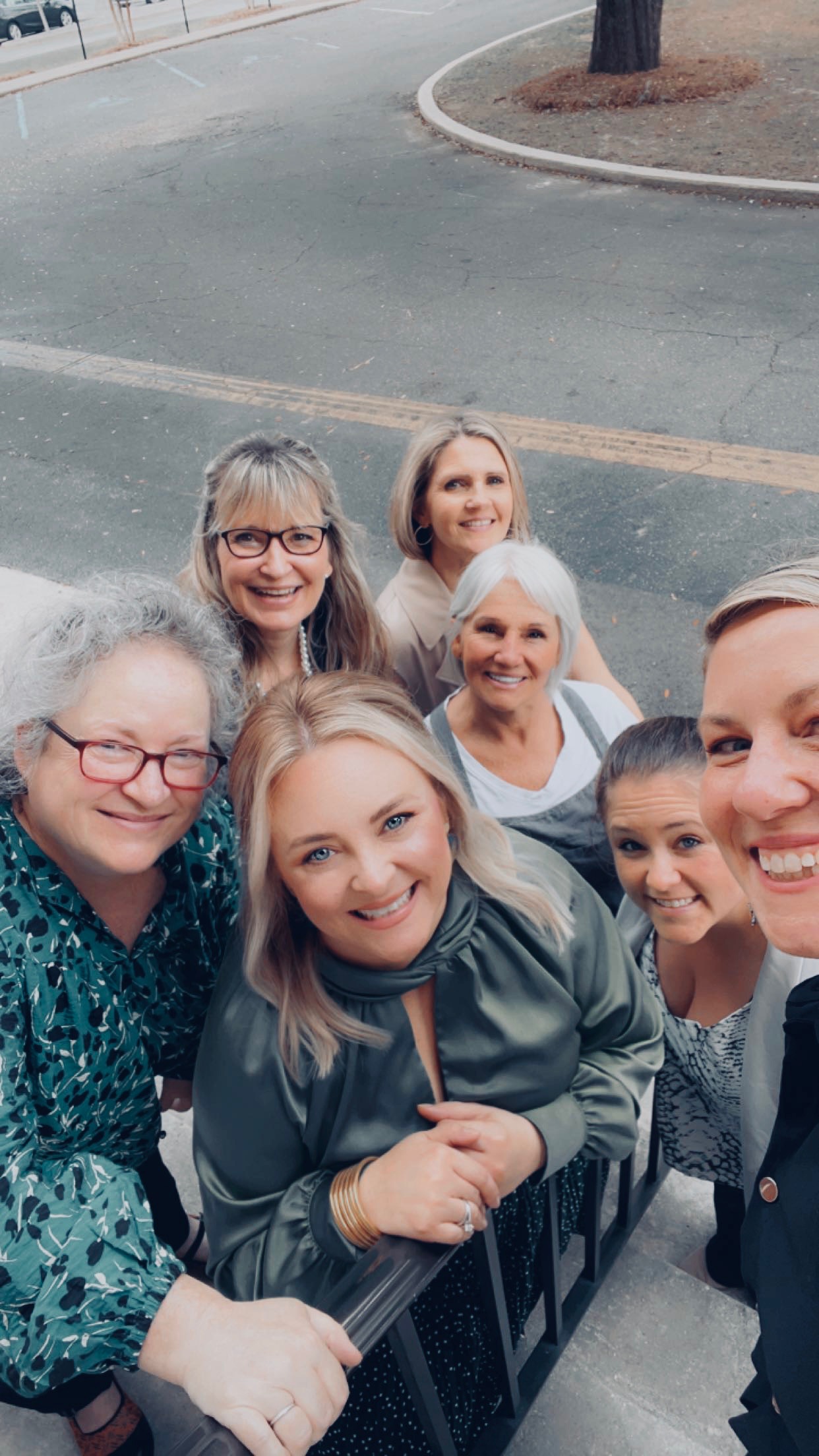 This image depicts a group of women standing in front fo the double doors to the center. 